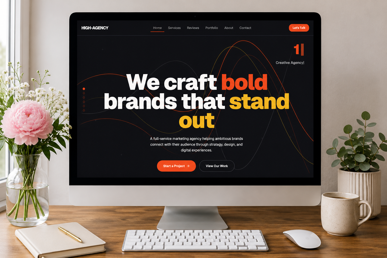 Design studio workspace with a colorful website design on screen